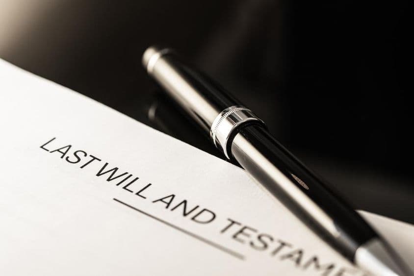 Close-up view of a will document with a slim pen.