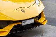 Close-up of Lamborghini logo on the car's front.