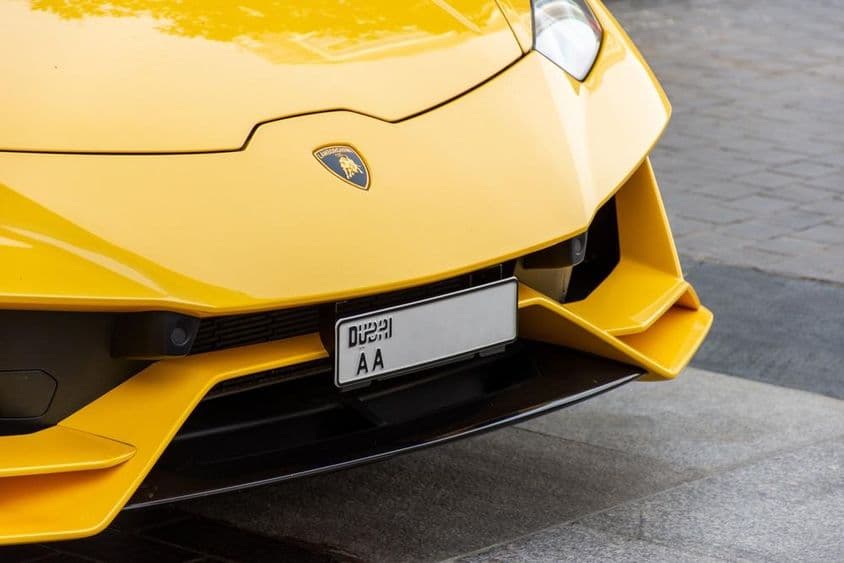 Close-up of Lamborghini logo on the car's front.