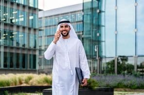 Arab Muslim businessman walking in Dubai business center.
