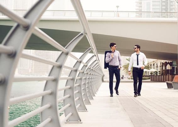 Businessmen walking in the Dubai Marina.