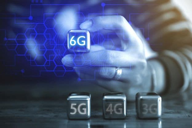 A young businessman using a cube-shaped steel ball, seeing the caption: 6G.