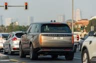 Cars stopped at a red light in Dubai City.