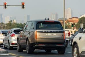 Cars stopped at a red light in Dubai City.