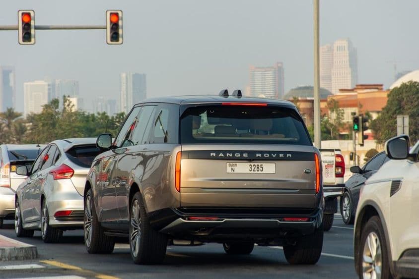 Cars stopped at a red light in Dubai City.