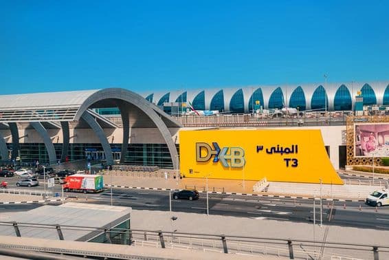 Entrance to the modern Dubai DXB airport terminal.