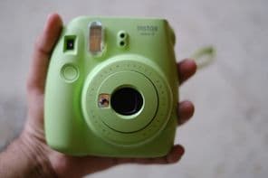 Mint-colored FUJIFILM Instax Mini instant camera by Fujifilm.