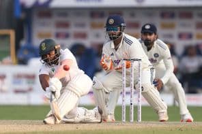 Cricket players on the field.
