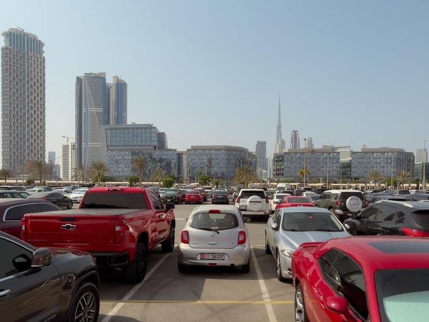 View of modern office buildings in Dubai's design district from a parking lot.