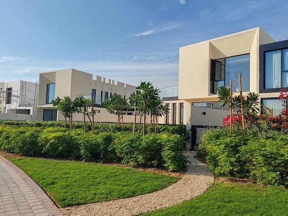 Cream-colored villas with black glass windows in Dubai.