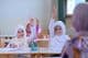 Muslim school students raising their hands.