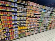 supermarket shelf with colorful canned goods, tuna, and vegetables