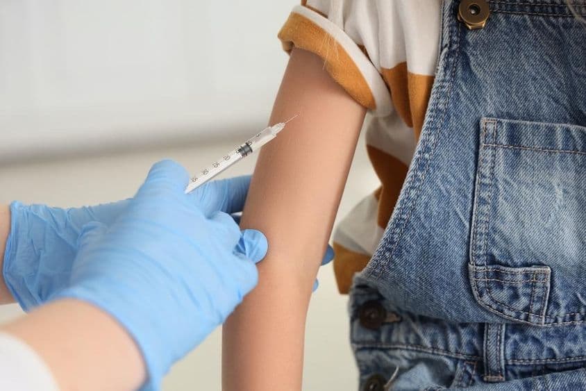 A young girl receiving a vaccine.