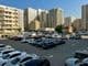 Large parking lot filled with cars in Sharjah, United Arab Emirates.