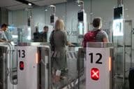 Air travelers passing through passport control checkpoints