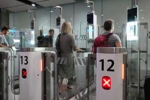 Air travelers passing through passport control checkpoints