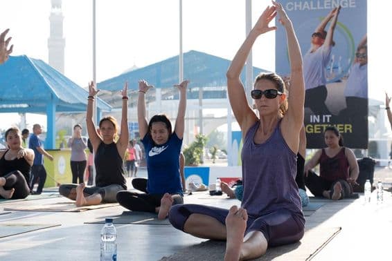Women doing aerobics and yoga during Dubai Fitness Challenge.