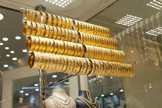 Gold bracelets in a display case.