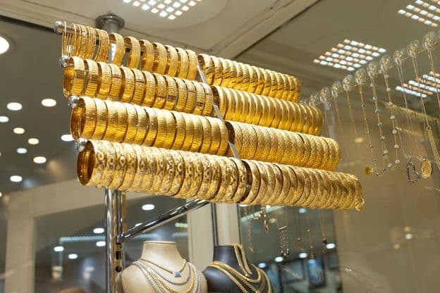 Gold bracelets in a display case.