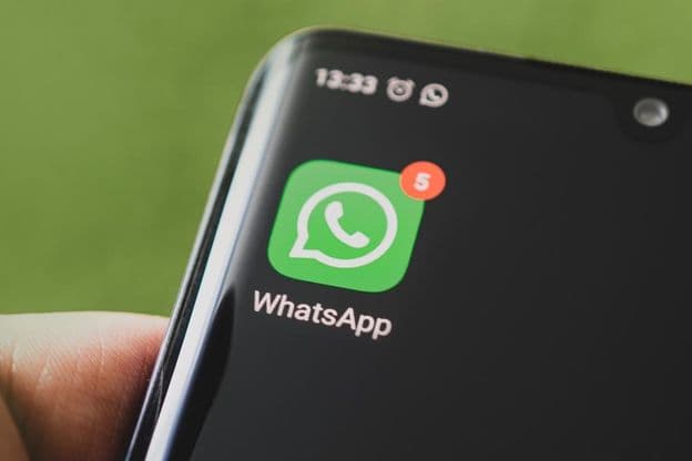 WhatsApp icon on a black smartphone