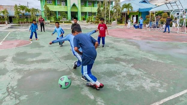 elementary school students playing soccer