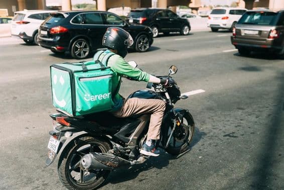 Courier delivering food on a scooter.