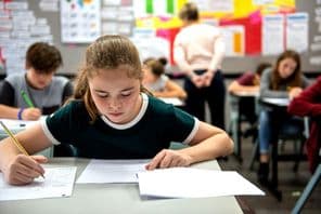 Students taking exams in a classroom.