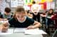Students taking exams in a classroom.