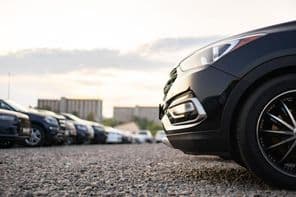 Cars parked in a gravel parking lot