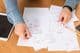 Man organizing various invoices