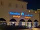 Illuminated logo of Carrefour market with Arabic brand name