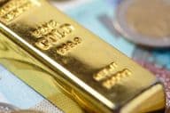 Gold bar on money paper