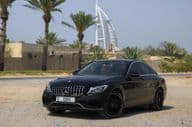 Mercedes Benz C300 parked outdoors in the city of Dubai.