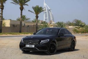 Mercedes Benz C300 parked outdoors in the city of Dubai.