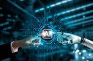 Robot and human hands connecting AI circuit board