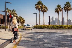 Woman standing on the street, waiting for a taxi.