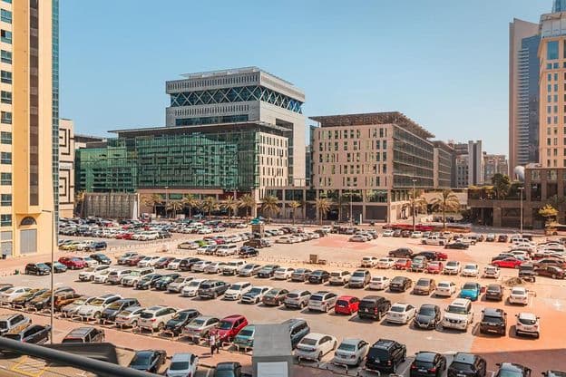 Large, crowded outdoor parking lot with hundreds of cars