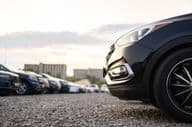 Cars parked in a gravel parking lot