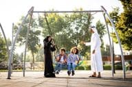 a family playing at the playground in Dubai