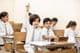 Happy Indian school child raising hand