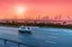 Highway and Dubai cityscape at sunset.