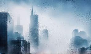 Cityscape view through a window on a rainy night