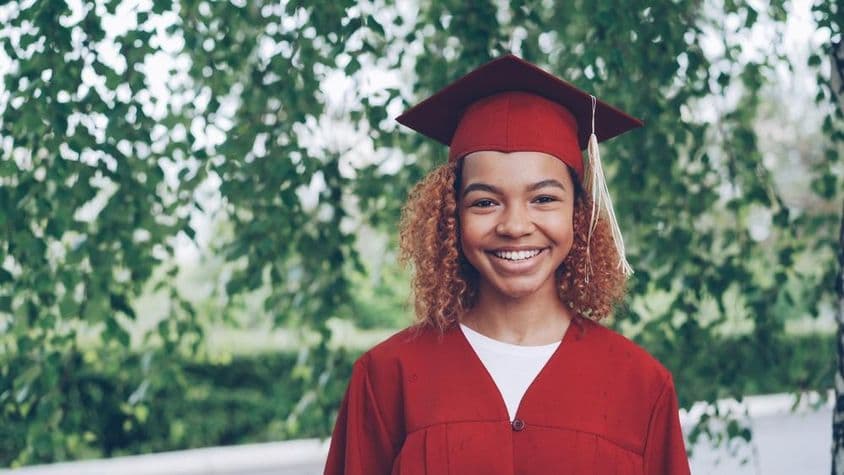 happy graduate in red gown
